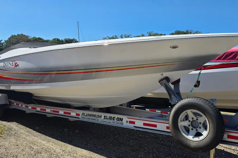 Slide: The Image of 2007 Donzi 38 ZR speedboat on trailer, featuring sleek design and vibrant stripes. - 0