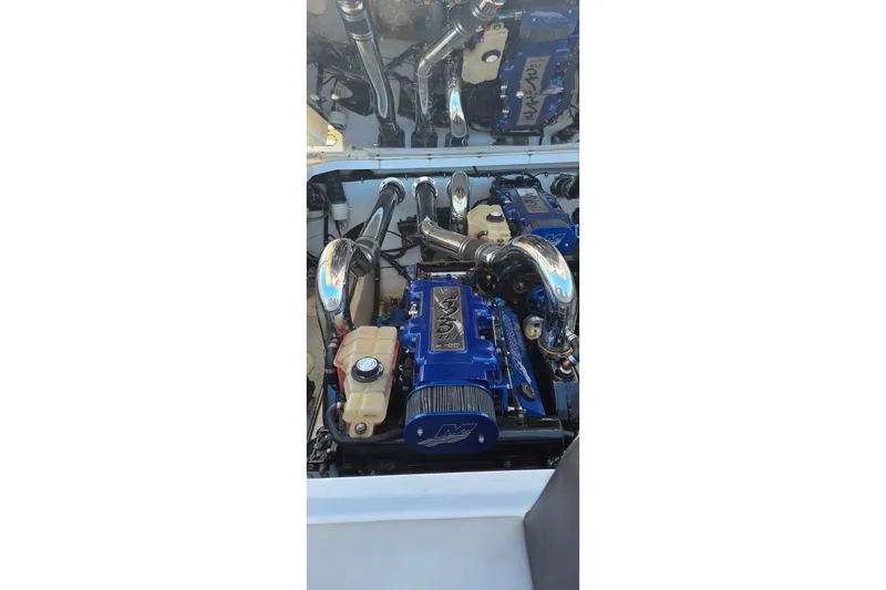 Slide: The Image of Engine compartment of a 2007 Donzi 38 ZR boat, featuring a powerful blue engine. - 24