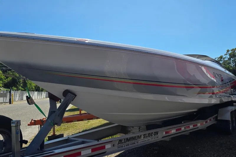 Slide: The Image of 2007 Donzi 38 ZR speedboat on trailer under clear blue sky. - 4