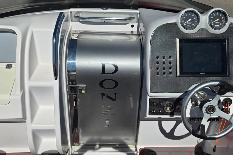 Slide: The Image of 2007 Donzi 38 ZR boat dashboard with steering wheel and gauges. - 11