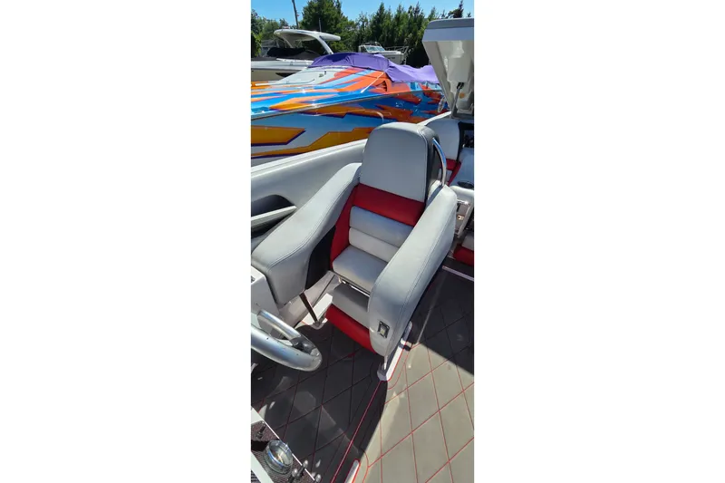 Slide: The Image of 2007 Donzi 38 ZR boat interior with gray and red seating, vibrant exterior design. - 37