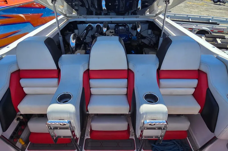 Slide: The Image of 2007 Donzi 38 ZR boat interior with red and white seating and cup holders. - 36