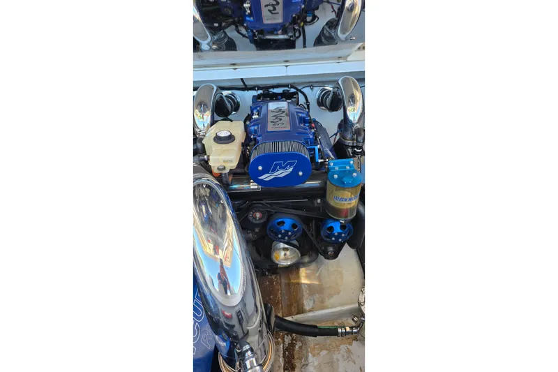 Slide: The Image of 2007 Donzi 38 ZR engine compartment with blue performance components and polished metal accents. - 26