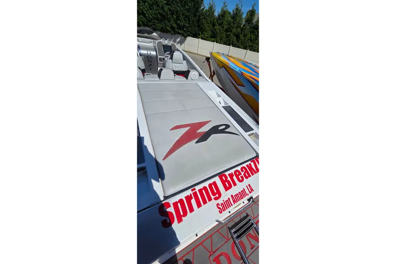 Slide: The Image of 2007 Donzi 38 ZR speedboat with "Spring Break" graphics, docked outdoors. - 17