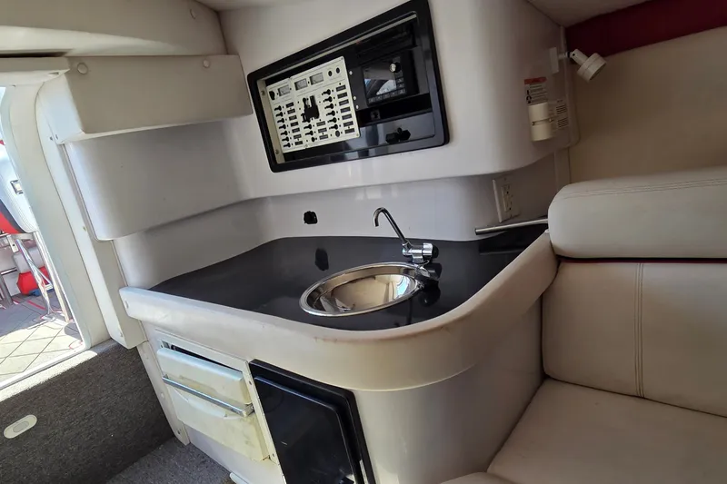 Slide: The Image of Interior of a 2007 Donzi 38 ZR boat featuring a compact kitchenette with sink and seating. - 34