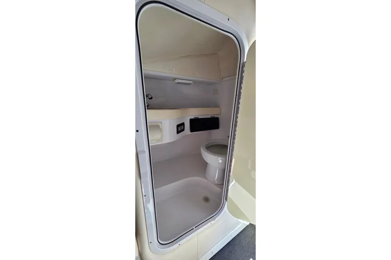 Slide: The Image of Interior of a 2007 Donzi 38 ZR boat bathroom with toilet and storage. - 33