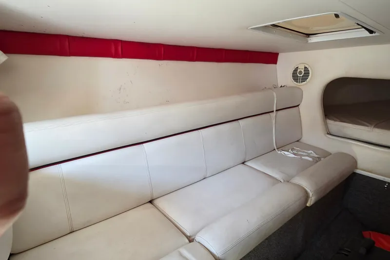 Slide: The Image of Interior of a 2007 Donzi 38 ZR boat with white seating and red accents. - 32