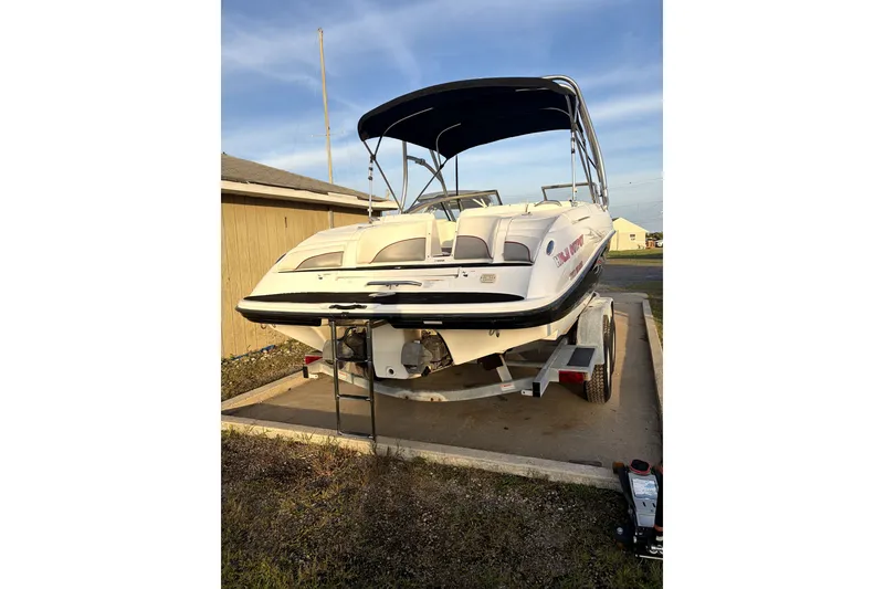 Slide: The Image of 2006 Yamaha Boats AR230 on trailer, parked outdoors with a canopy. - 2