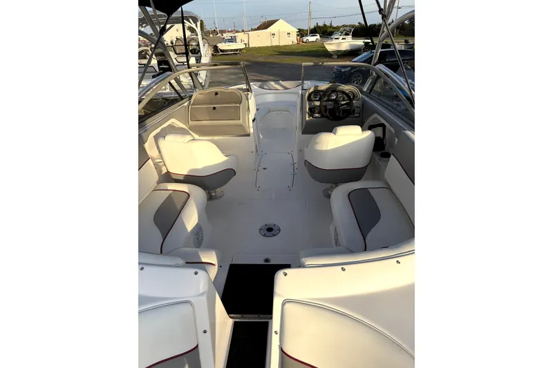 Slide: The Image of 2006 Yamaha Boats AR230 interior with white seating and steering console. - 11