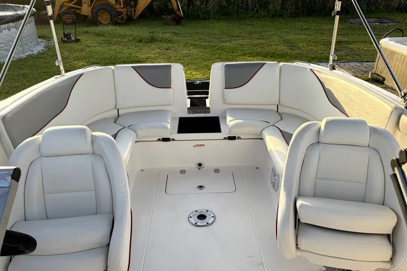 Slide: The Image of 2006 Yamaha Boats AR230 interior with white seating and spacious layout. - 9