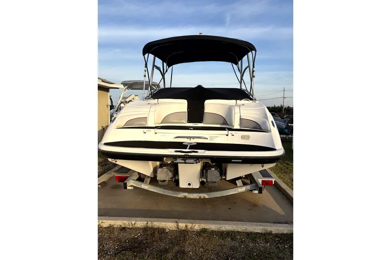 Slide: The Image of 2006 Yamaha Boats AR230 on trailer, rear view with canopy, parked outdoors. - 4