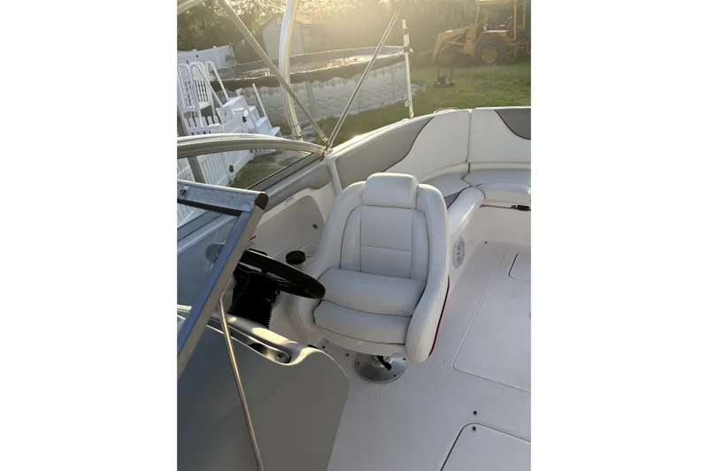 Slide: The Image of 2006 Yamaha Boats AR230 interior with steering wheel and seating in sunlight. - 5