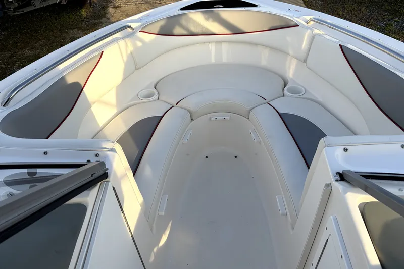 Slide: The Image of 2006 Yamaha Boats AR230 interior with white and gray seating, cup holders, and open deck. - 10