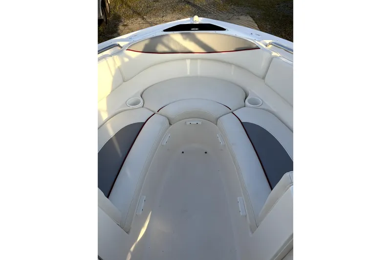 Slide: The Image of 2006 Yamaha Boats AR230 interior seating with cup holders and white upholstery. - 12