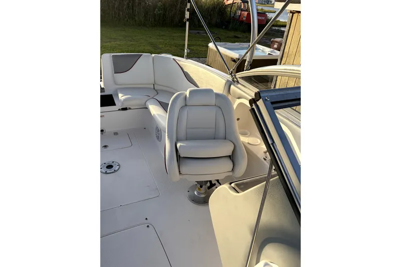 Slide: The Image of 2006 Yamaha AR230 boat interior with white seating and steering area. - 8
