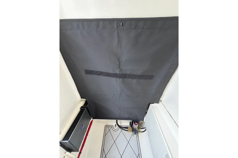 Slide: The Image of 2019 Mako 284 Center Console interior with black panel and equipment. - 32