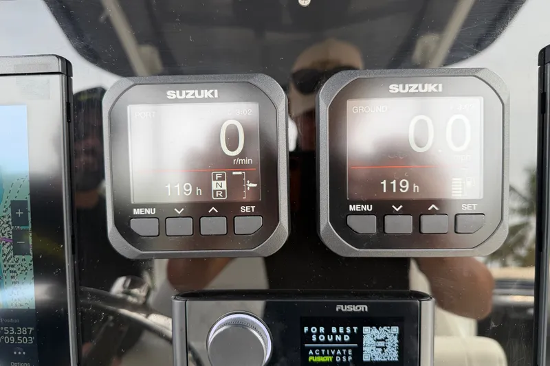 Slide: The Image of Close-up of Suzuki digital displays on a 2019 Mako 284 Center Console boat. - 17