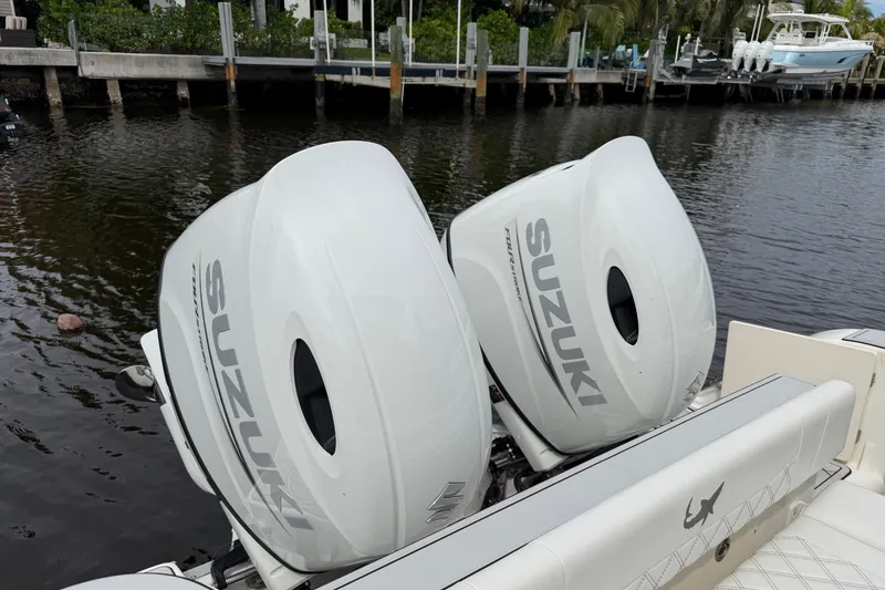 Slide: The Image of Twin Suzuki outboard motors on a 2019 Mako 284 Center Console boat. - 35