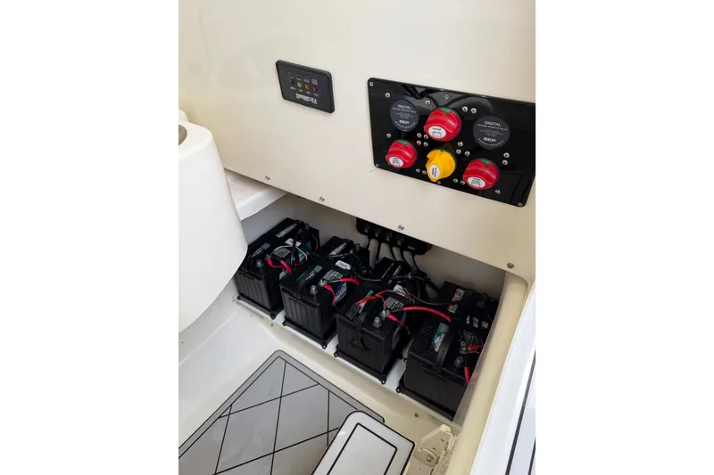 Slide: The Image of Battery compartment of a 2019 Mako 284 Center Console boat with control panel. - 30
