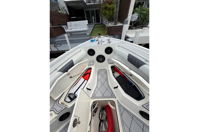 Slide: The Image of 2019 Mako 284 Center Console boat interior with open storage compartments and speakers. - 34