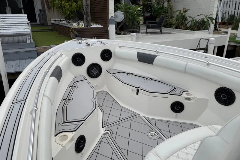 Slide: The Image of 2019 Mako 284 Center Console boat interior with speakers and cushioned seating. - 19