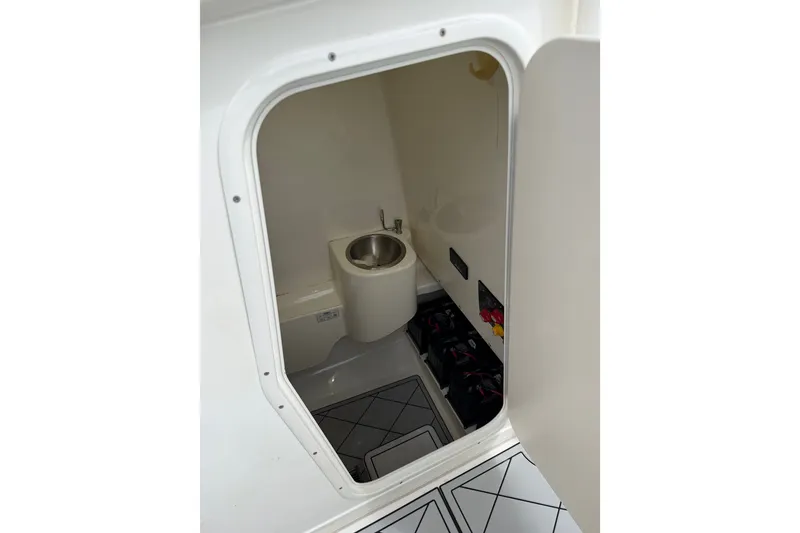 Slide: The Image of 2019 Mako 284 Center Console boat interior with sink and storage area. - 26