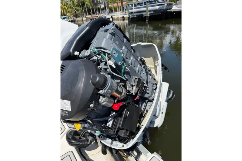 Slide: The Image of 2019 Mako 284 Center Console boat engine, detailed view by the water. - 37