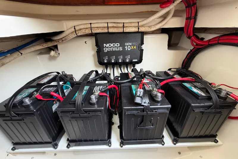 Slide: The Image of Four marine batteries with NOCO Genius charger in a 2019 Mako 284 Center Console boat. - 31