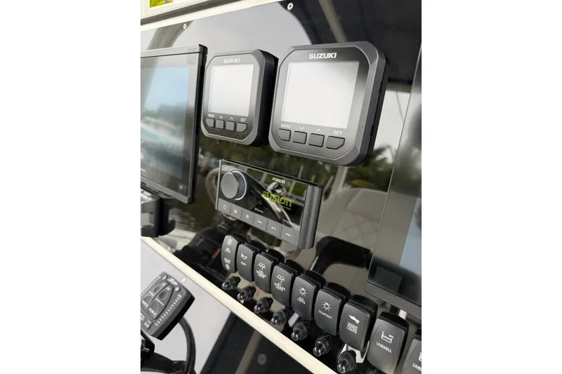 Slide: The Image of Control panel of a 2019 Mako 284 Center Console boat with Suzuki displays. - 16