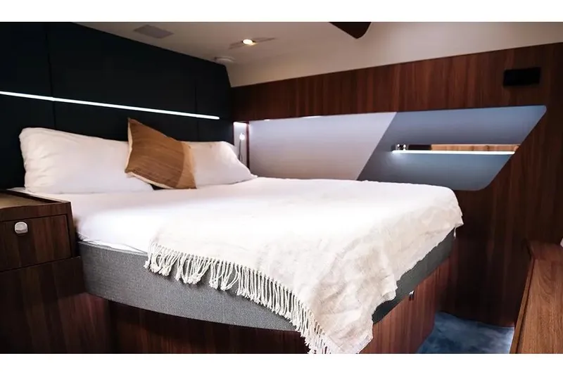 Slide: The Image of Manufacturer Provided Image: Luxurious bedroom interior of 2026 Aquila 46 Coupe yacht with modern design and cozy bedding. - 9