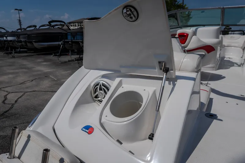 Slide: The Image of 2009 Crownline 260 LS boat interior with open storage compartment and speaker. - 20