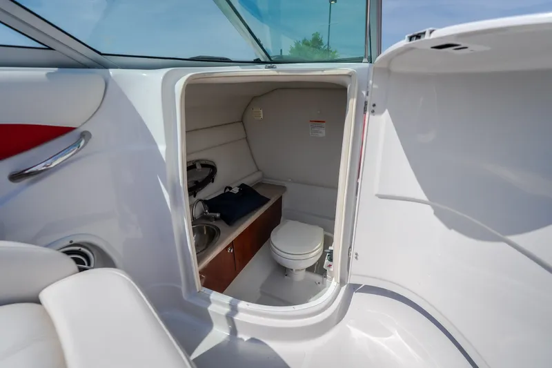 Slide: The Image of 2009 Crownline 260 LS boat interior with compact bathroom and sink. - 39