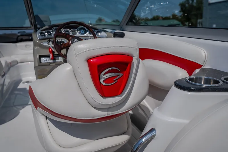 Slide: The Image of Interior of a 2009 Crownline 260 LS boat, featuring red and white seating. - 33