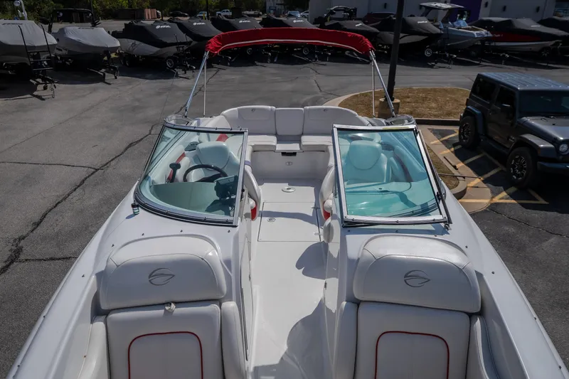 Slide: The Image of 2009 Crownline 260 LS boat with red canopy, parked in a lot. - 22