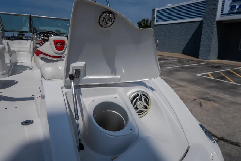 Slide: The Image of 2009 Crownline 260 LS boat interior with open storage compartment and speaker. - 19