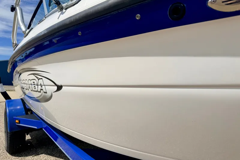 Slide: The Image of 2007 Moomba Outback V boat with blue and white exterior on a trailer. - 15