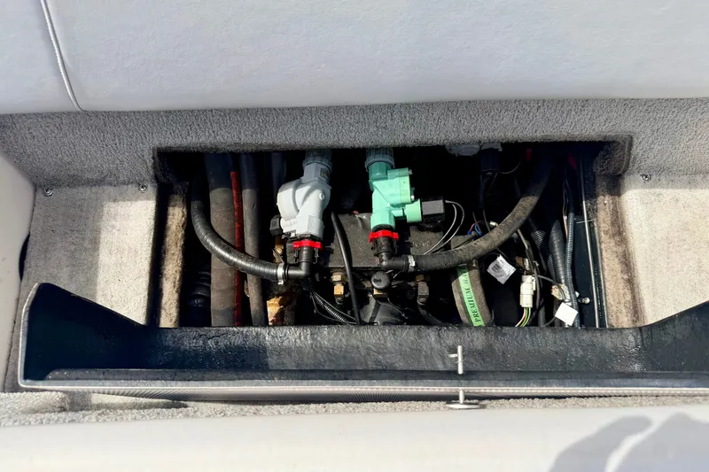 Slide: The Image of Engine compartment of a 2007 Moomba Outback V boat, showing hoses and components. - 36