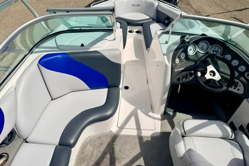 Slide: The Image of 2007 Moomba Outback V boat interior with blue and gray seating, steering wheel, and dashboard. - 78