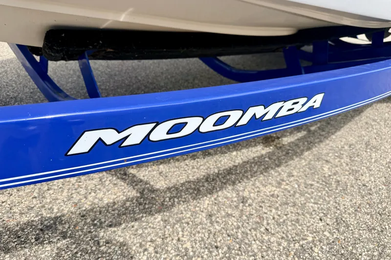Slide: The Image of Blue Moomba Outback V 2007 boat trailer on asphalt surface. - 82
