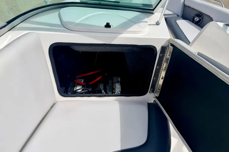 Slide: The Image of 2007 Moomba Outback V boat storage compartment with battery and jumper cables. - 44