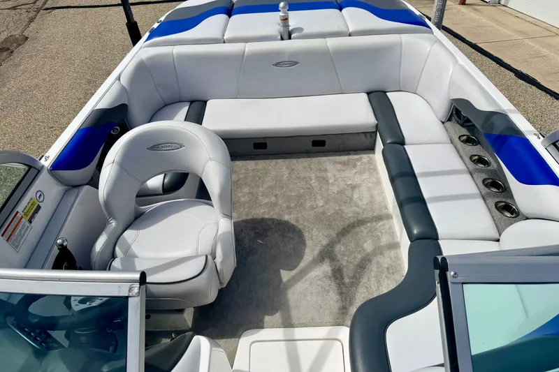 Slide: The Image of 2007 Moomba Outback V boat interior with white and blue seating, cup holders, and steering wheel. - 63