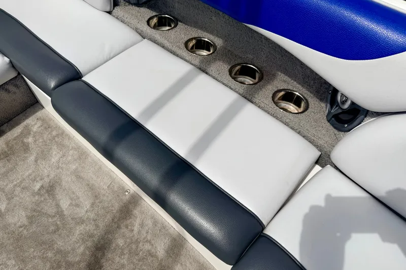 Slide: The Image of 2007 Moomba Outback V interior seating with cup holders and blue accents. - 40