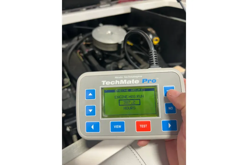 Slide: The Image of Hand holding TechMate Pro displaying engine hours for 2007 Moomba Outback V. - 87