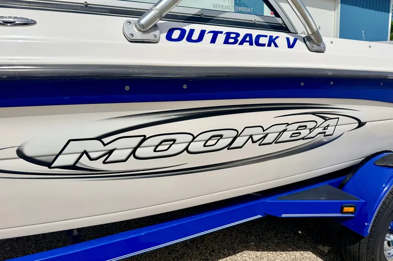 Slide: The Image of 2007 Moomba Outback V boat with bold logo and blue accents. - 6
