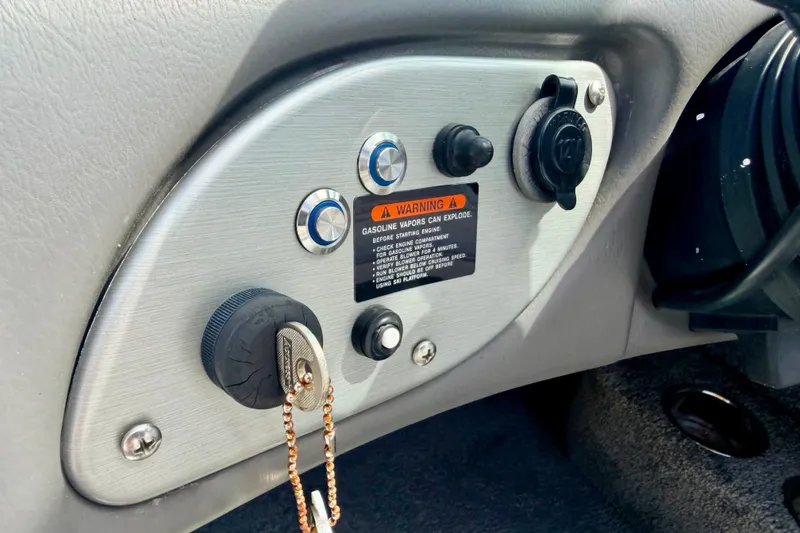 Slide: The Image of Dashboard controls of a 2007 Moomba Outback V boat with warning label and ignition key. - 53