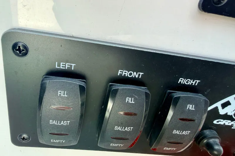 Slide: The Image of Ballast control panel of 2007 Moomba Outback V boat with fill and empty switches. - 58