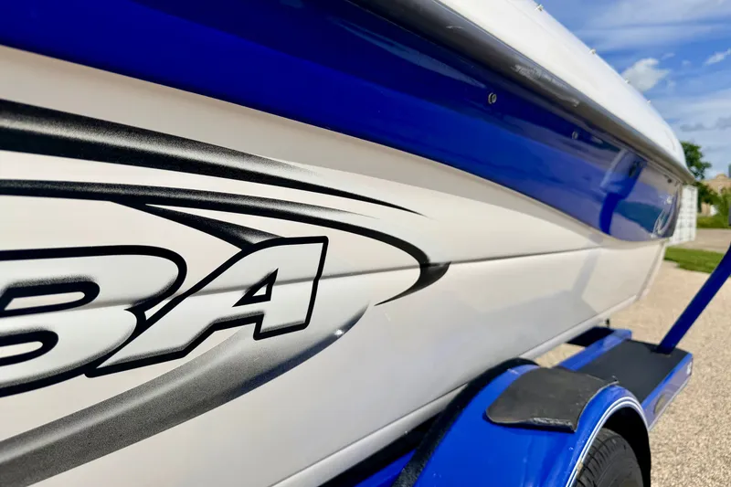 Slide: The Image of 2007 Moomba Outback V boat with blue and white design on a trailer. - 8