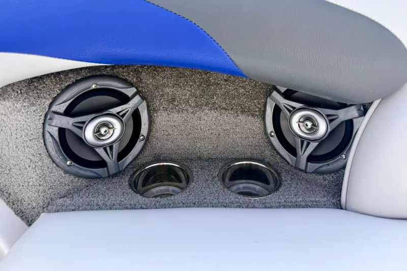 Slide: The Image of 2007 Moomba Outback V boat interior speakers and cup holders on gray carpet. - 33
