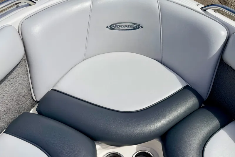 Slide: The Image of 2007 Moomba Outback V boat interior seating with logo, featuring gray and white upholstery. - 67