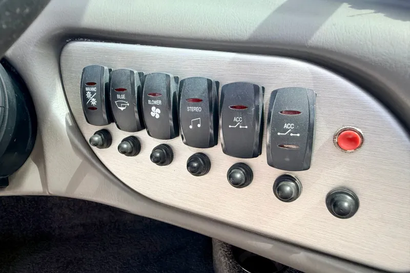 Slide: The Image of Dashboard switches of a 2007 Moomba Outback V boat, featuring various controls. - 54